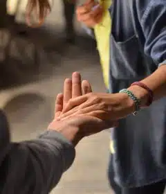 man and woman holding hands on street