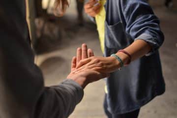 man and woman holding hands on street